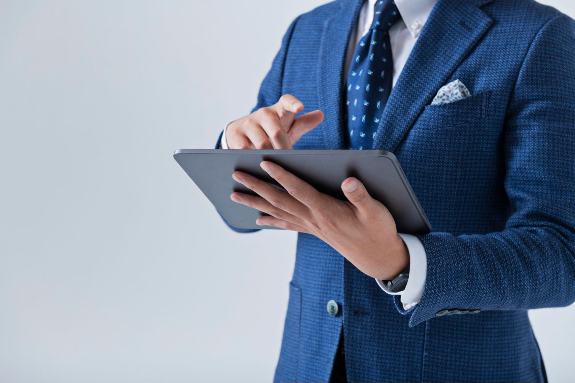 スーツを着た男性が動画を見る様子